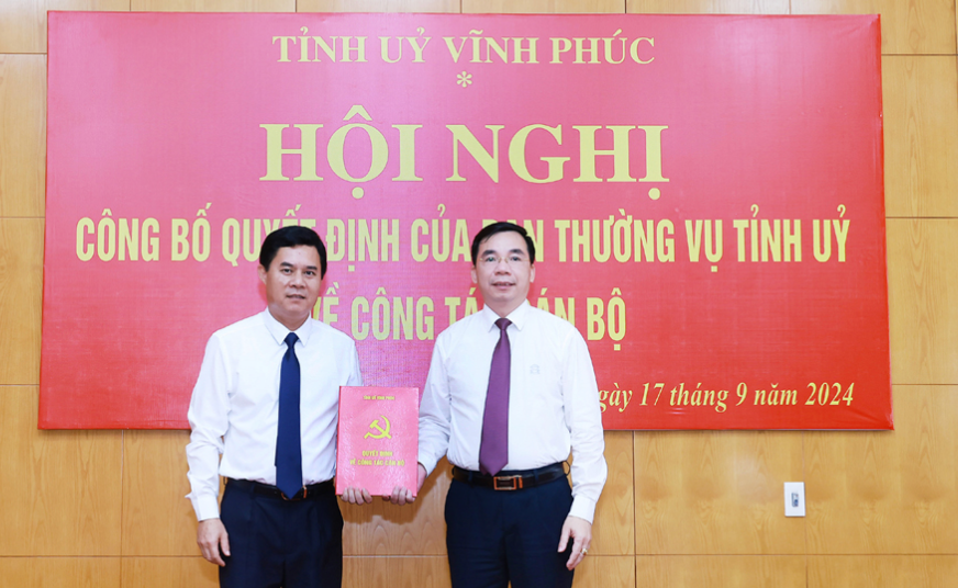 Trưởng Ban Tuyên giáo Tỉnh ủy Bùi Huy Vĩnh (bên phải) trao quyết định cho ông Hà Văn Quyết. Ảnh: Trà Hương