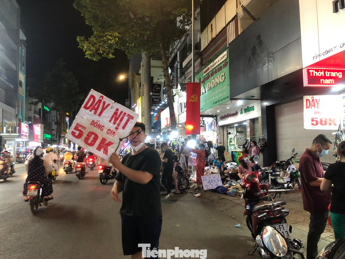 Nhân viên một shop thời trang cầm bảng ra giữa đường chào mời khách. "Gần nửa tháng trước Tết, lượng khách đến mua sắm cũng không đông. Đêm nay chúng tôi cố gắng bán được bao nhiêu hay bấy nhiêu rồi dọn hàng, nghỉ Tết thôi" - một nhân viên bán quần áo thời trang cho biết.