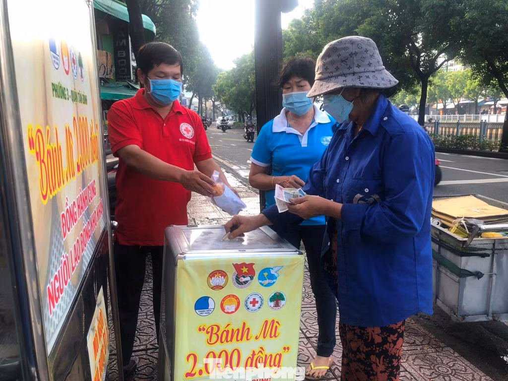 Nâng niu ổ bánh mì nóng hổi, bên trong ngập thịt, pate… bà Nguyễn Thị Trinh (56 tuổi, làm nghề nhặt ve chai) phấn khởi: “Mua bánh mì ở đây, tôi tiết kiệm được gần 20.000 đồng ăn uống trong ngày. Trong thời buổi vật giá tăng cao, có được những quầy hàng bán giá hỗ trợ thế này thì đỡ cho người nghèo nhiều lắm”. Nâng niu ổ bánh mì nóng hổi, bên trong ngập thịt, pate… bà Nguyễn Thị Trinh (56 tuổi, làm nghề nhặt ve chai) phấn khởi: “Mua bánh mì ở đây, tôi tiết kiệm được gần 20.000 đồng ăn uống trong ngày. Trong thời buổi vật giá tăng cao, có được những quầy hàng bán giá hỗ trợ thế này thì đỡ cho người nghèo nhiều lắm”.