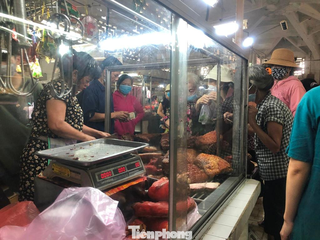 Một tiệm heo quay trong chợ Hòa Bình nườm nượp khách chen nhau mua Một tiệm heo quay trong chợ Hòa Bình nườm nượp khách chen nhau mua