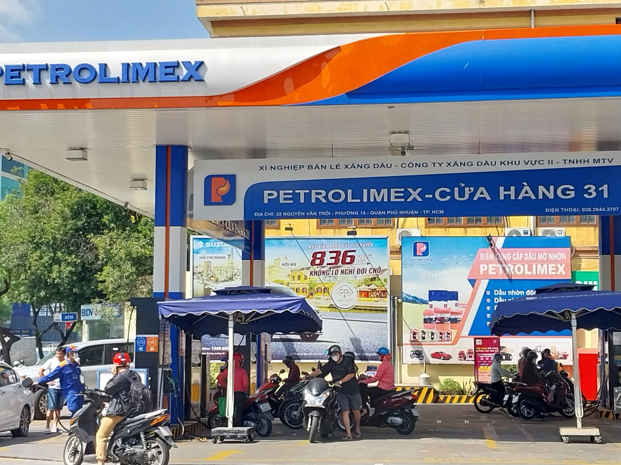 Người dân mua xăng RON95-V tại cửa hàng Petrolimex trưa 23/12. Người dân mua xăng RON95-V tại cửa hàng Petrolimex trưa 23/12.