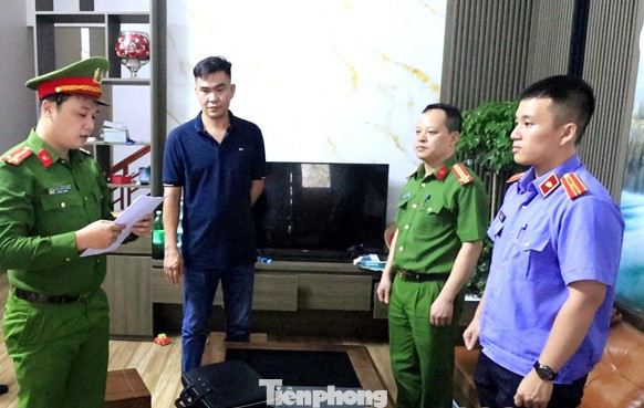 Bị can Thân Tiến Huy (giữa) nghe lệnh khởi tố vụ án, khởi tố bị can. Ảnh: A.K