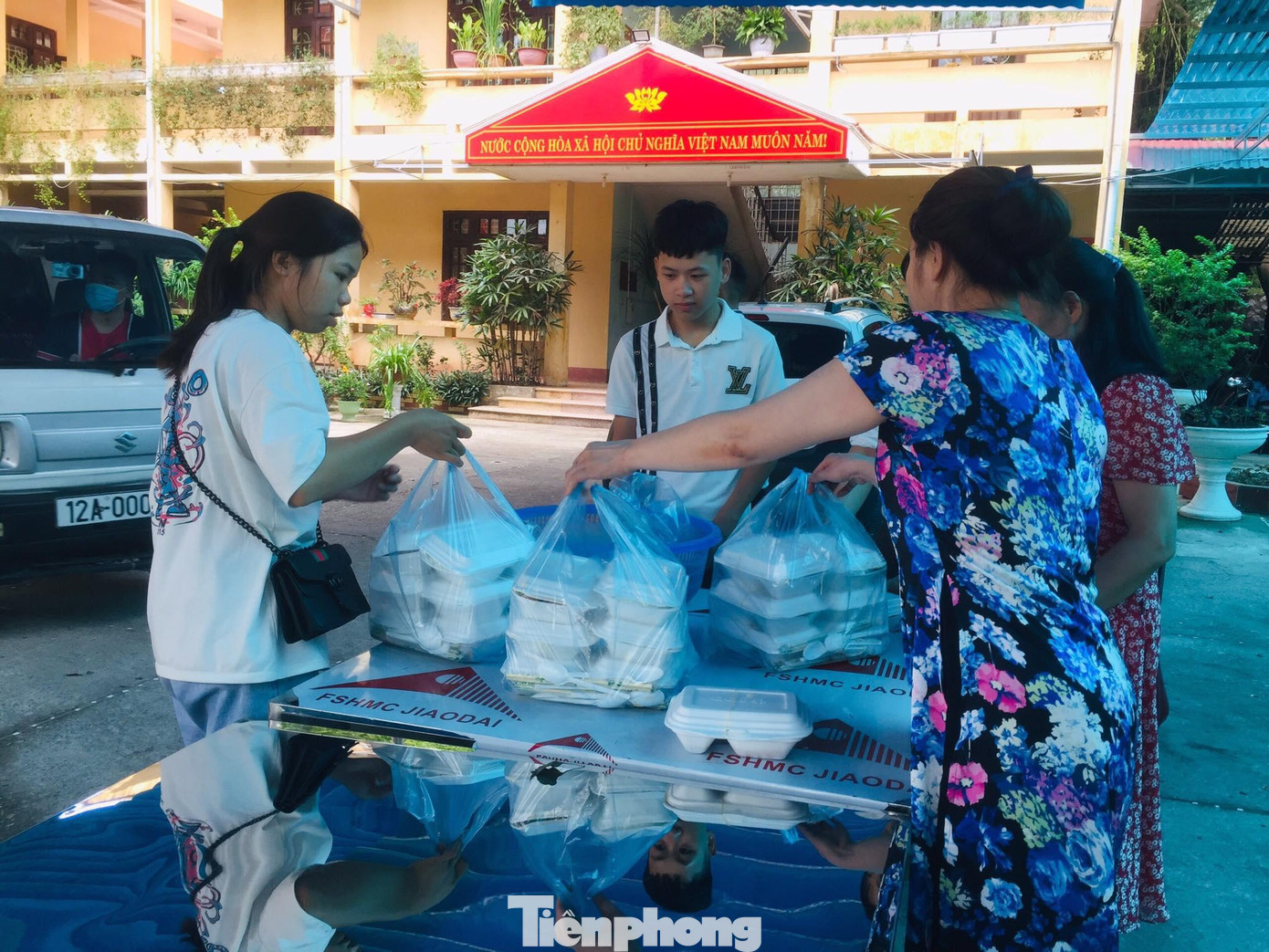 Các thầy cô giáo ở Trung tâm GDNN-GDTX huyện Cao Lộc phát cơm nóng cho các em -Ảnh: Duy Chiến