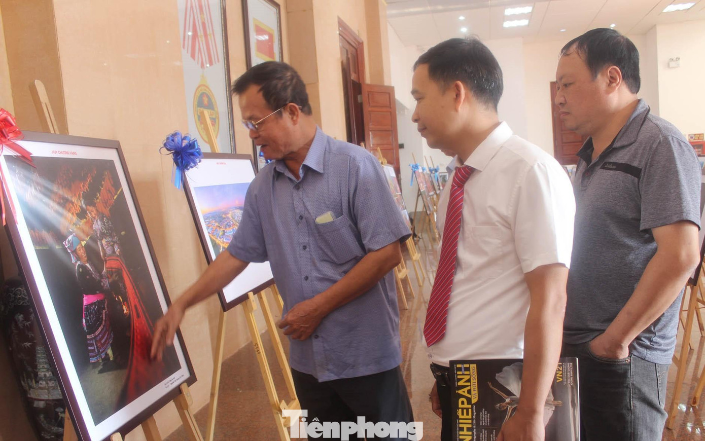 Các đại biểu thích thú, bình phẩm tác phẩm "May áo mới" (Huy chương Vàng) -Ảnh: PV