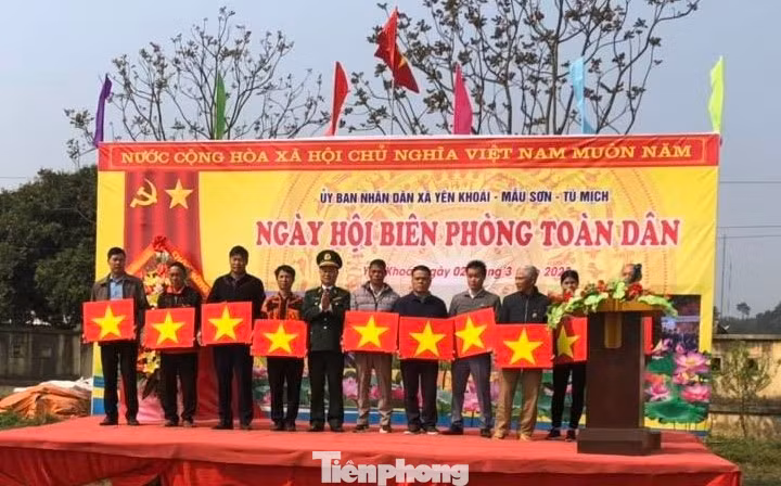 Các hộ dân sống trên địa bàn biên giới 3 xã của huyện Lộc Bình nhận cờ Tổ quốc. Ảnh: Duy Chiến