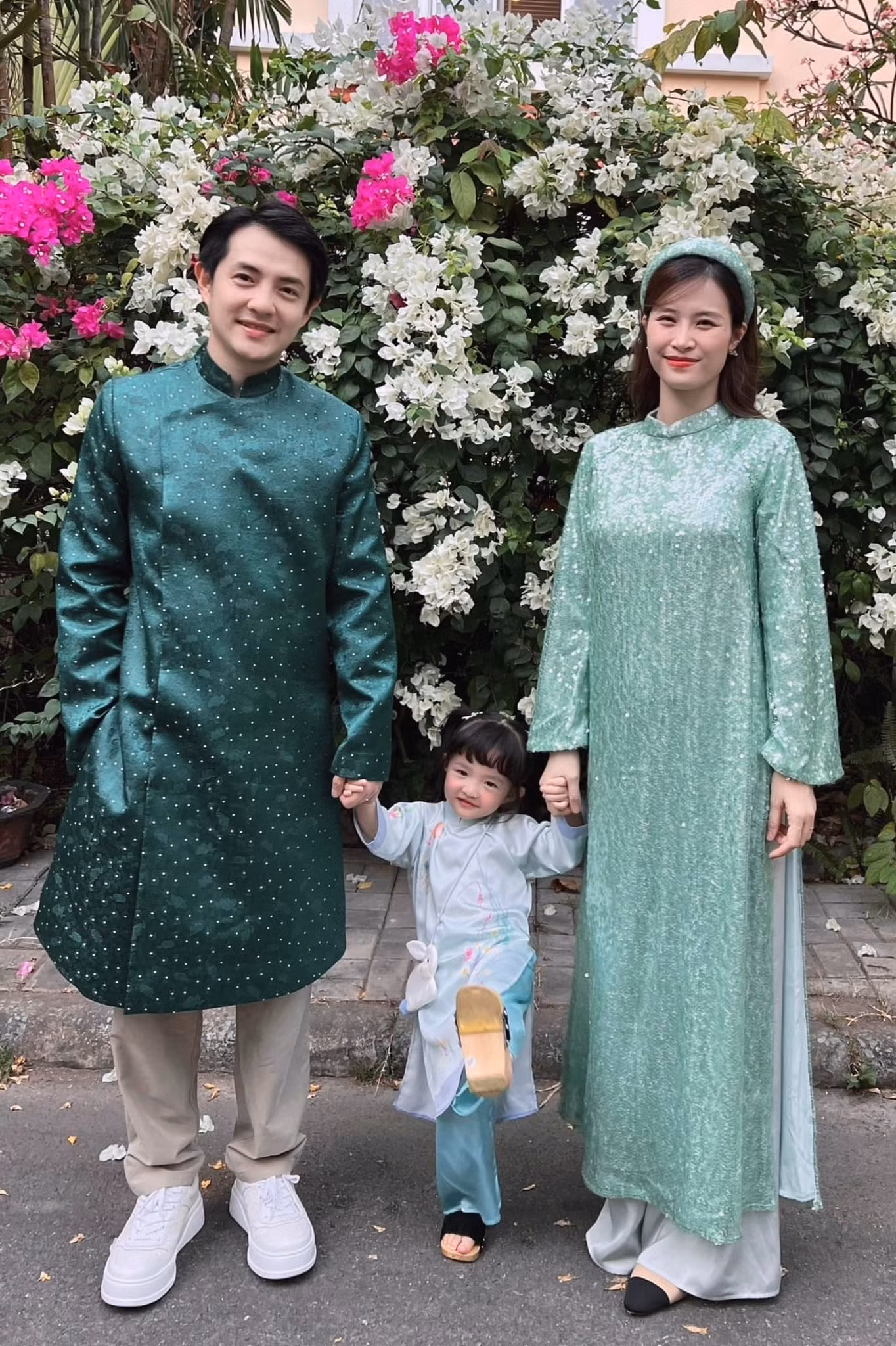 Vợ chồng Đông Nhi và ông Cao Thắng mặc ton-sur-ton dịp năm mới Giáp Thìn. Nữ ca sĩ và chồng, con gái đều chọn áo dài để du xuân. Trong khi Ông Cao Thắng chọn áo dài nam cách tân, giọng ca Bad Boy hóa phụ nữ xưa với áo dài phom dáng truyền thống.