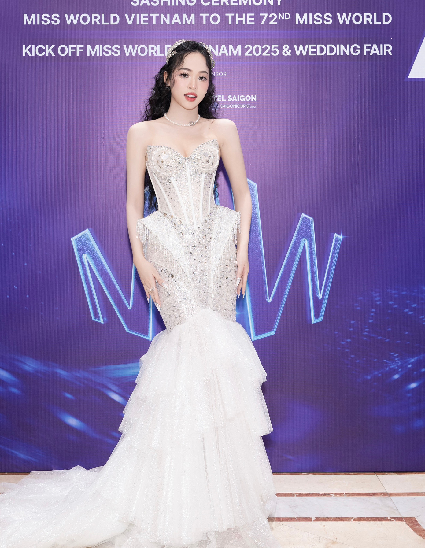 Á hậu Trịnh Thùy Linh khoe dáng với thiết kế đuôi cá, phần chiết eo làm nổi bật vòng eo thon. Phong cách trang điểm nhẹ nhàng giúp cô tôn lên vẻ đẹp ngọt ngào.