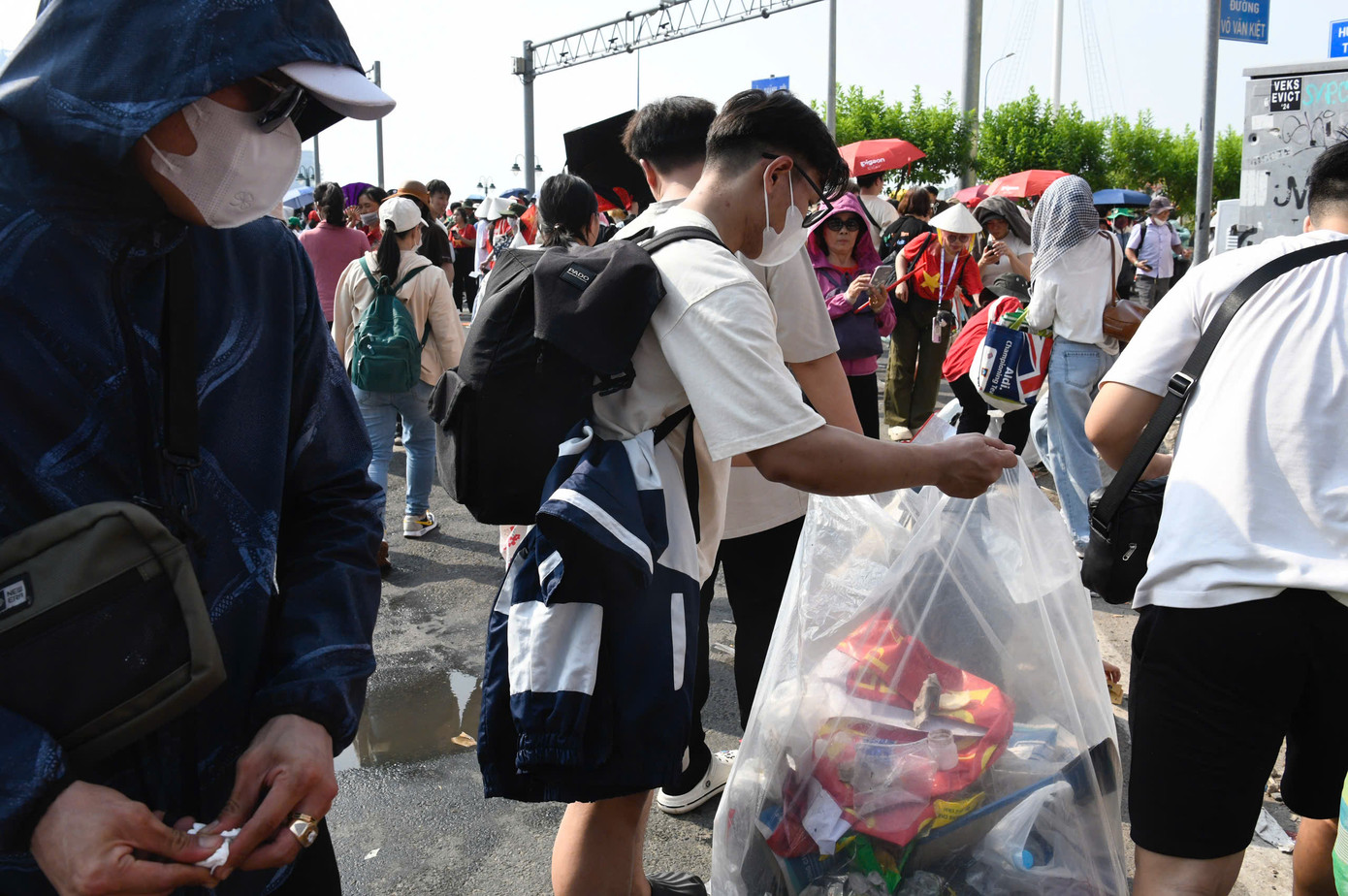 Người dân tản ra sau lễ để lại cảnh tượng nhiều rác, trong khi các bạn trẻ cặm cụi thu dọn từng ghế nhựa, bao bì và thức ăn bỏ lại.