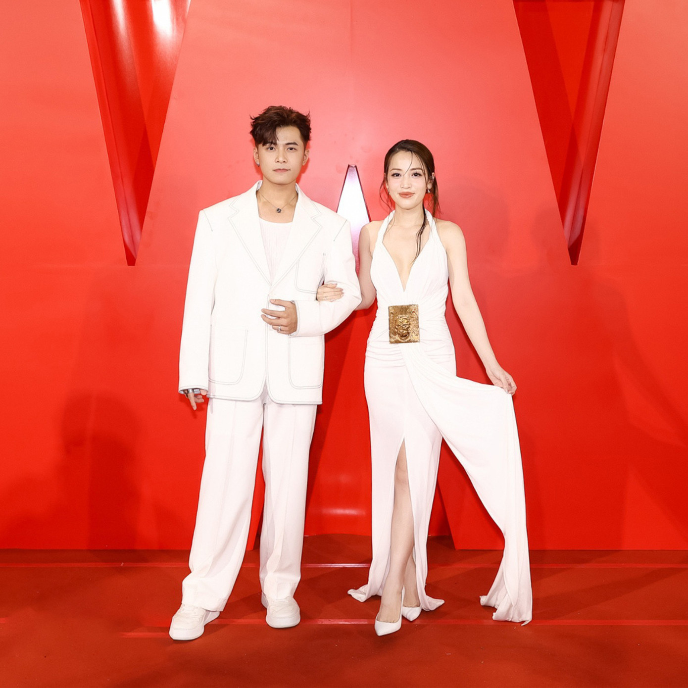 Puka và Gin Tuấn Kiệt mặc đồng điệu, khoác tay suốt thời gian đi thảm đỏ. Trang phục của Puka có phần xẻ chân cao, khoét ngực gợi cảm.