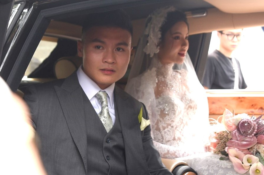 Vợ chồng Quang Hải và Chu Thanh Huyền bước lên xế hộp trước khi đến địa điểm tổ chức tiệc cưới chính thức.