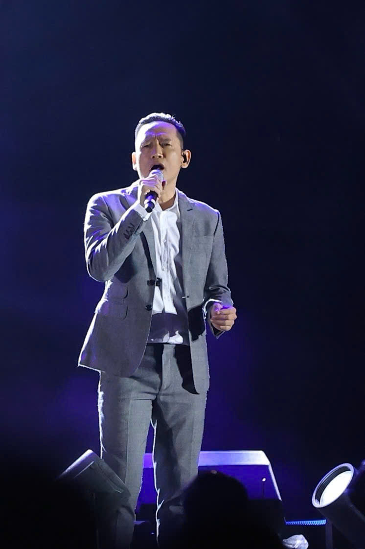 Duy Mạnh sẵn sàng hưởng ứng và đồng hành với Tuấn Hưng, gác bỏ mọi hiềm khích cá nhân. Chương trình diễn ra ngoài trời trong thời tiết mưa gió chắc chắn cũng ảnh hưởng không ít tới sức lực và tâm lý của hai ca sĩ. Đôi lúc Duy Mạnh thở còn to hơn hát khi phải thực hiện vũ đạo cùng vũ đoàn, dẫn đến những nhận xét đùa bỡn kiểu “chửi hay hơn hát” từ phía khán giả. Dù sao cũng phải ghi nhận họ không chỉ ở lòng tốt, tinh thần thiện nguyện vì đồng bào mà còn ở sự cố gắng để làm mới bản thân. Chỉ là họ cần thêm thời gian để ngấm. Ảnh: Trọng Tài.