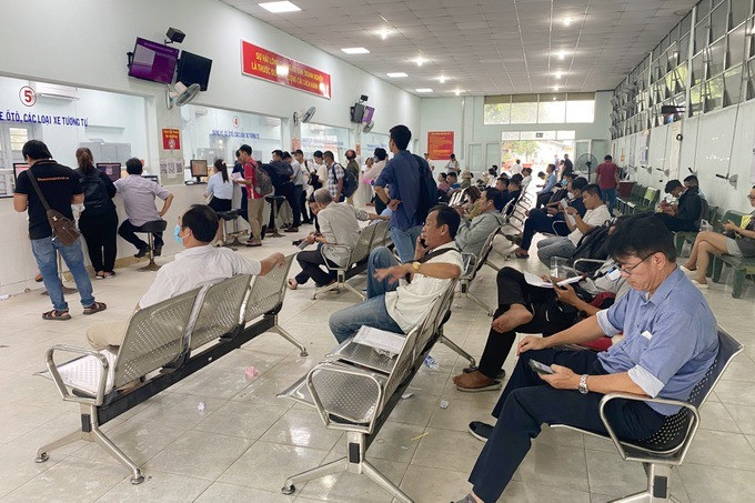 Nhiều người đứng chờ Website đăng ký xe của Cục CSGT hoạt động trở lại (Ảnh: Hoàng Quy).