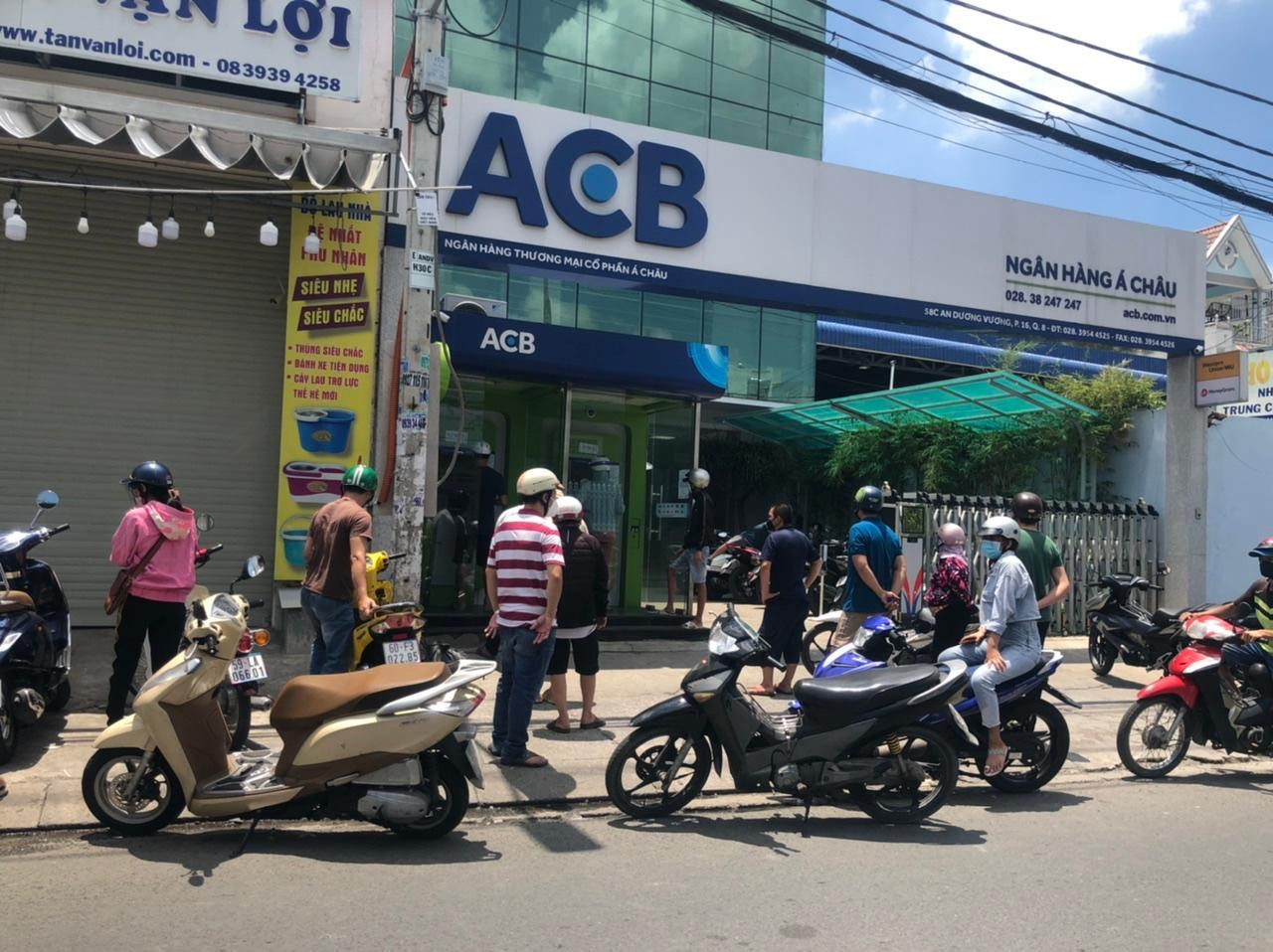 Người dân xếp hàng chờ rút tiền tại một cây ATM trên đường An Dương Vương (quận Bình Tân)