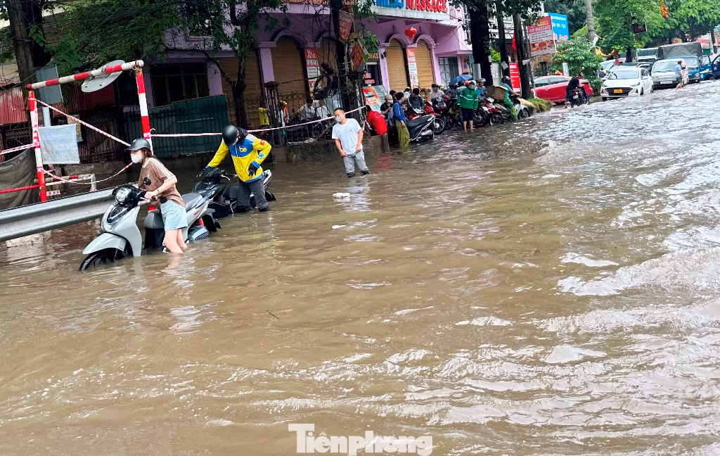 Tuyến đường Phan Trọng Tuệ - Phùng Hưng ngập đến đầu gối người đi đường, phương tiện không thể đi lại. Cảnh người dân lội nước, dắt xe đã diễn ra từ sáng sớm đến 13h hôm nay.