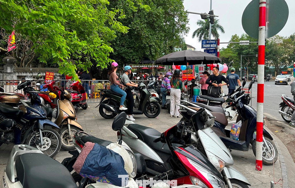 Tại bãi xe trước cổng ra vào đền Quán Thánh (Ba Đình), giá trông giữ xe máy có bảng niêm yết là 5.000 đồng/lượt xe máy nhưng những ngày qua, bãi xe tại đây đã thu công 10.000 đồng/lượt.