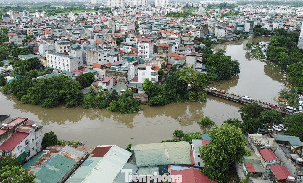 Trong khi đó mực nước sông Nhuệ tại địa bàn Hà Đông PV Tiền Phong ghi nhận đang vượt mực nước bình thường hơn 1 mét. Lãnh đạo Công ty Thủy lợi Sông Nhuệ cho biết, với mức nước này Cty phải phát đi báo động cấp 1 (cấp mức sông ngập cao nhất). Ảnh chụp tại cầu Xa La 11h sáng 24/7.