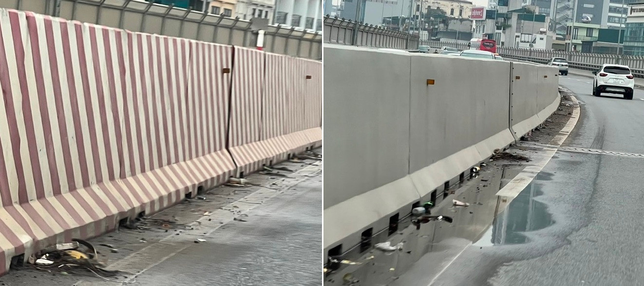 Rác thải và nước đọng trên đường Vành đai 2 trên cao Hà Nội .