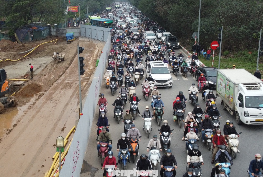 Phương tiện vất vả đi qua hàng rào công trường.