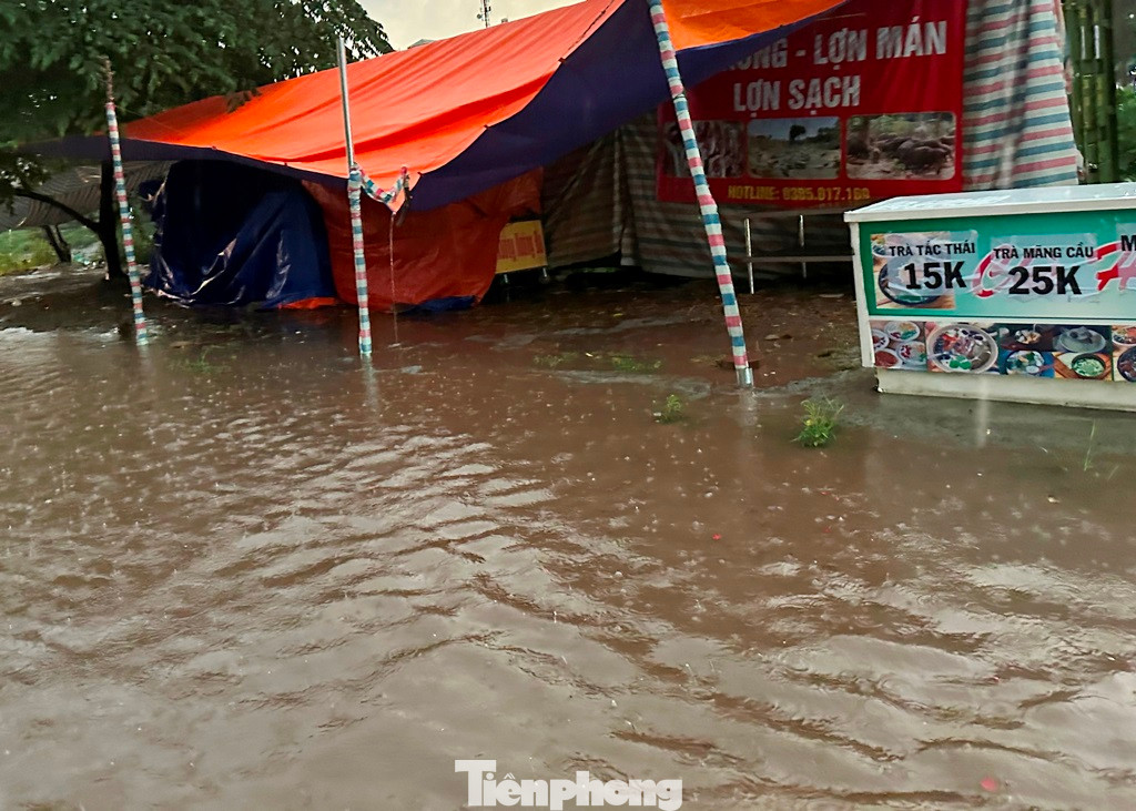 Trên các tuyến đường Nguyễn Hữu Thọ - Nghiêm Xuân Yên - Kim Giang nước ngập trắng các tuyến phố, tràn lên cả vỉa hè, nhiều cửa hàng đã phải nghỉ kinh doanh.
