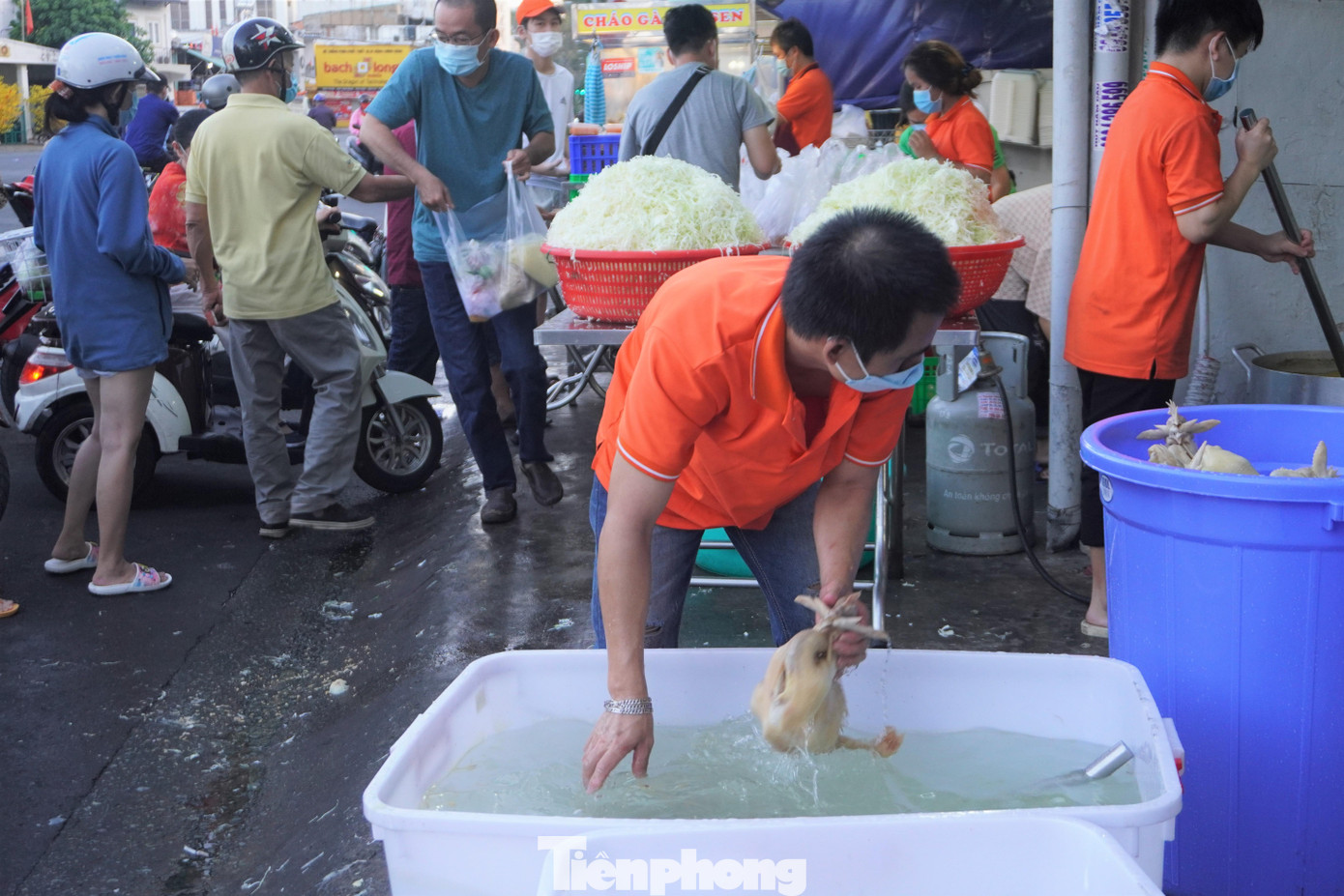 Nhân viên tất bật luộc và trần 4-5 thùng gà qua nước lạnh cho thịt gà săn chắc trước khi bán cho khách.