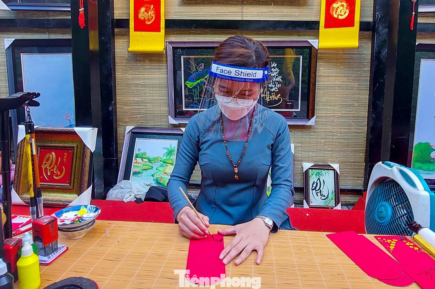 Năm thứ 6 làm "bà đồ" tại đây, chị Võ Thị Kiều Trâm chia sẻ đây là năm rất đặc biệt so với mọi năm. Dù tình hình dịch bệnh đã được kiểm soát ổn định tại TPHCM nhưng chị vẫn cẩn thận trang bị đầy đủ kính chắn giọt bắn, khẩu trang và nước sát khuẩn để đảm bảo an toàn cho bản thân cũng như khách đến xin chữ.