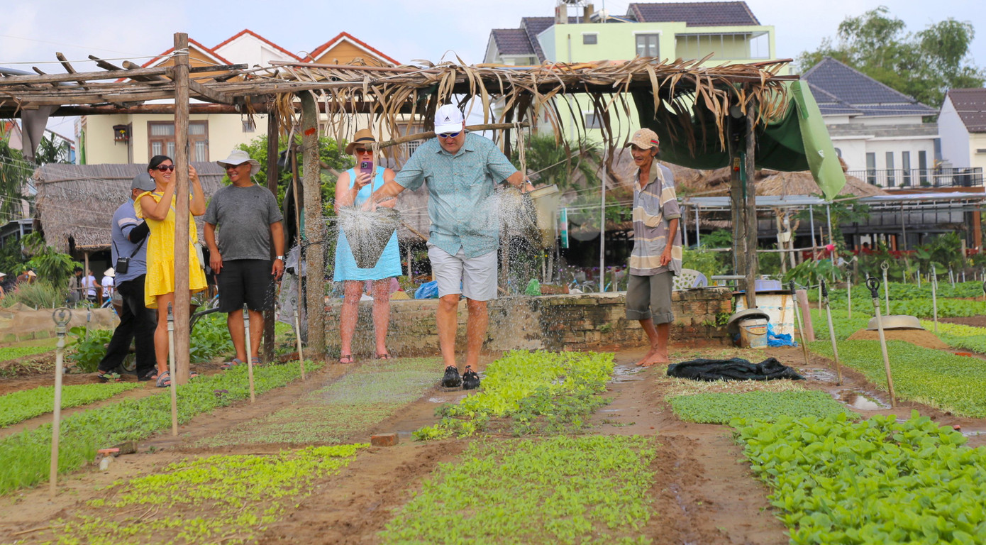 Du khách trải nghiệm ở làng rau Trà Quế.