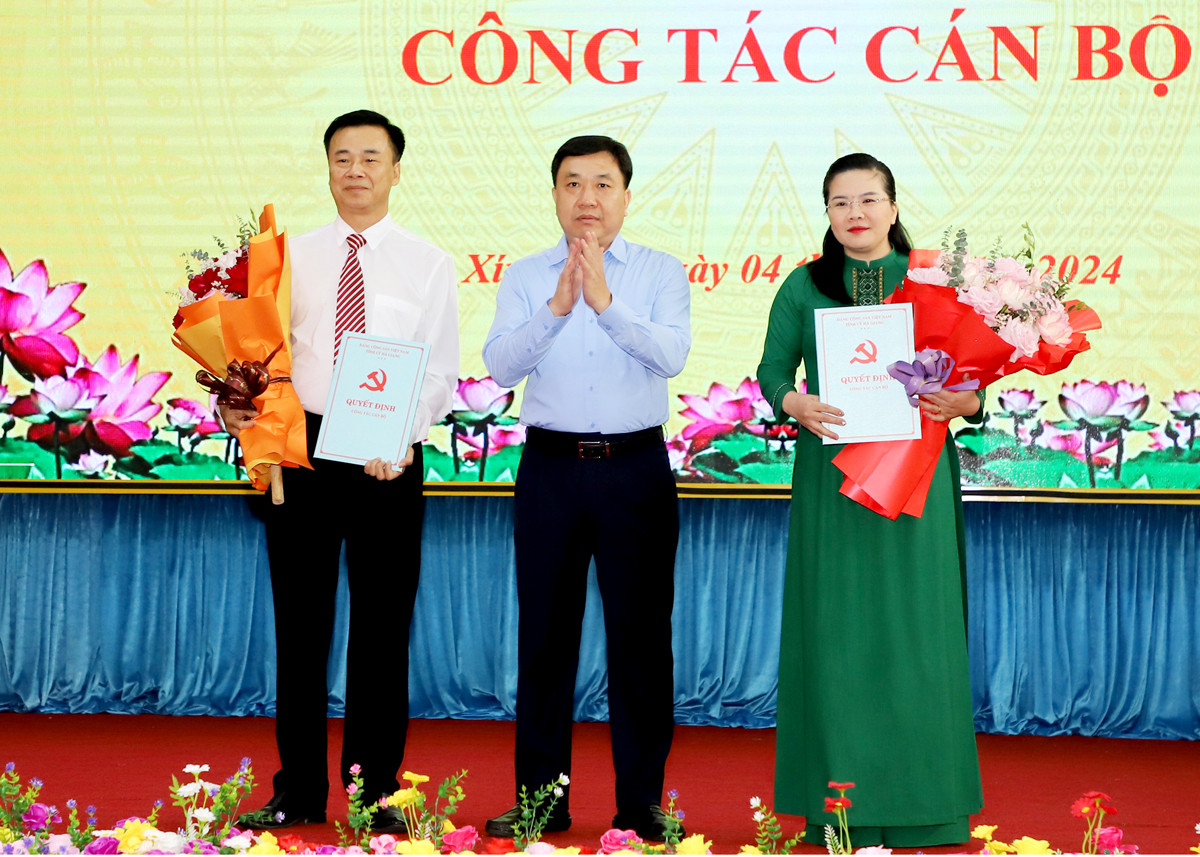 Quyền Bí thư Tỉnh ủy Hà Giang Nguyễn Mạnh Dũng trao quyết định, tặng hoa chúc mừng đồng chí Hoàng Nhị Sơn và Đỗ Thị Hương.