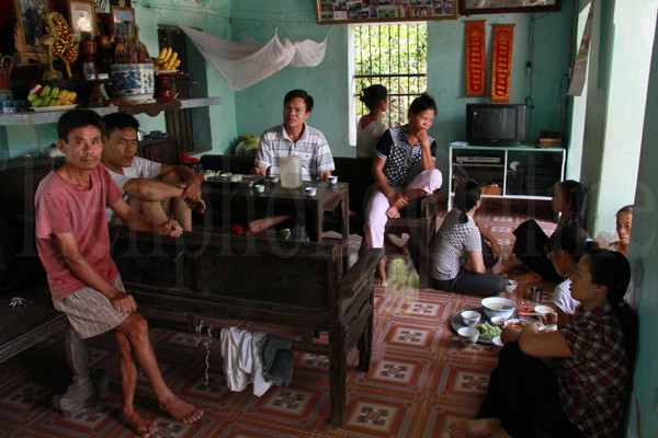 Họ hàng, hàng xóm kéo đến nhà Hậu bàn chuyện đưa ông Vệ (bố Hậu - bị bệnh thần kinh, đau ngực, phổi) đi viện và chuyện làm thủ tục cho Hậu nhập học. Có lẽ, vài ngày nữa, lúc Hậu nhập trường, cũng là lúc bố Hậu nhập viện. Ảnh: Trường Phong