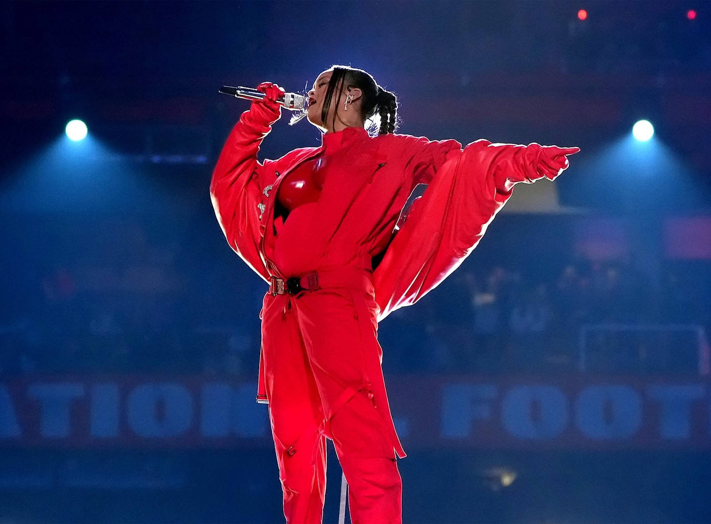 Rihanna rực rỡ trong bộ jumpsuit mặc cùng breastplate đỏ được Loewe custom riêng, khoác ngoài là chiếc áo khoác da Alaïa.