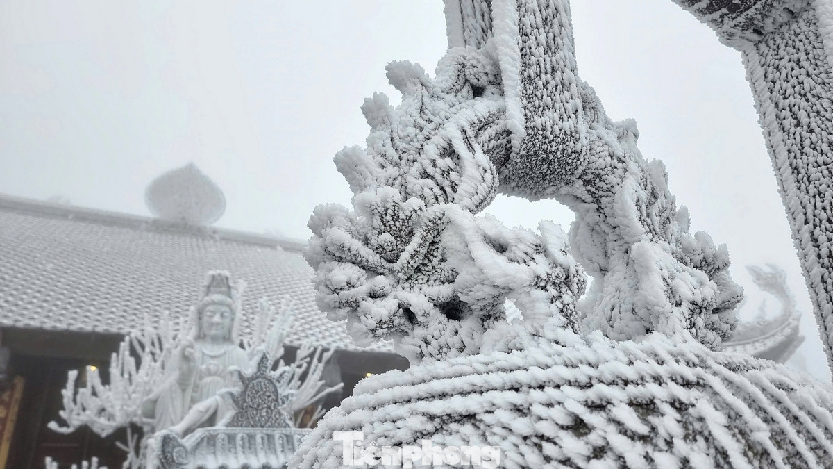 Tuyết rơi phủ trắng sàn gỗ khu đặt biểu tượng Fansipan và cây, cỏ trên đỉnh núi. Hiện tại, nhiệt độ tại đỉnh Fansipan chỉ khoảng -2 độ C.