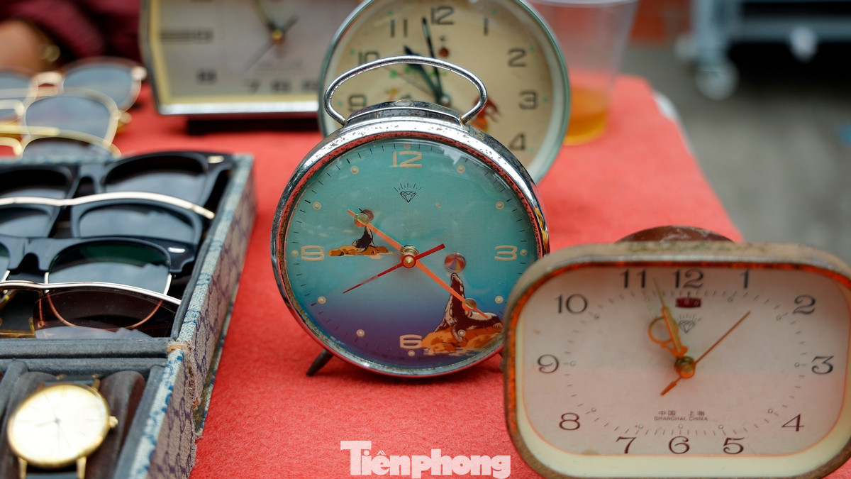 Tiếng người rao bán, tiếng mặc cả, tiếng cười nói hòa lẫn vào nhau tạo nên một bức tranh sống động của khu chợ. Những gian hàng chất đầy quần áo đủ kiểu dáng, từ áo khoác, áo len mùa đông đến những bộ đồ vintage độc đáo, tất cả đều được treo kín trên giá hoặc bày ngổn ngang trên mặt đất.