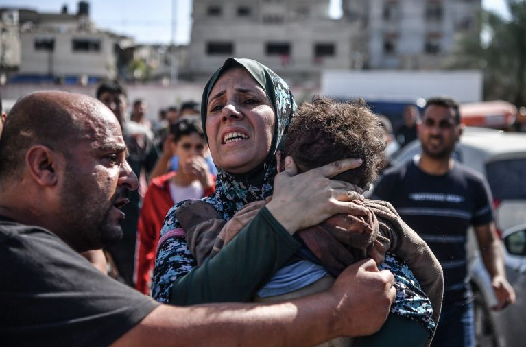 Một người phụ nữ ôm cậu con trai 3 tuổi thiệt mạng sau cuộc không kích xuống thành phố Gaza ngày 26/10. (Ảnh: Getty)