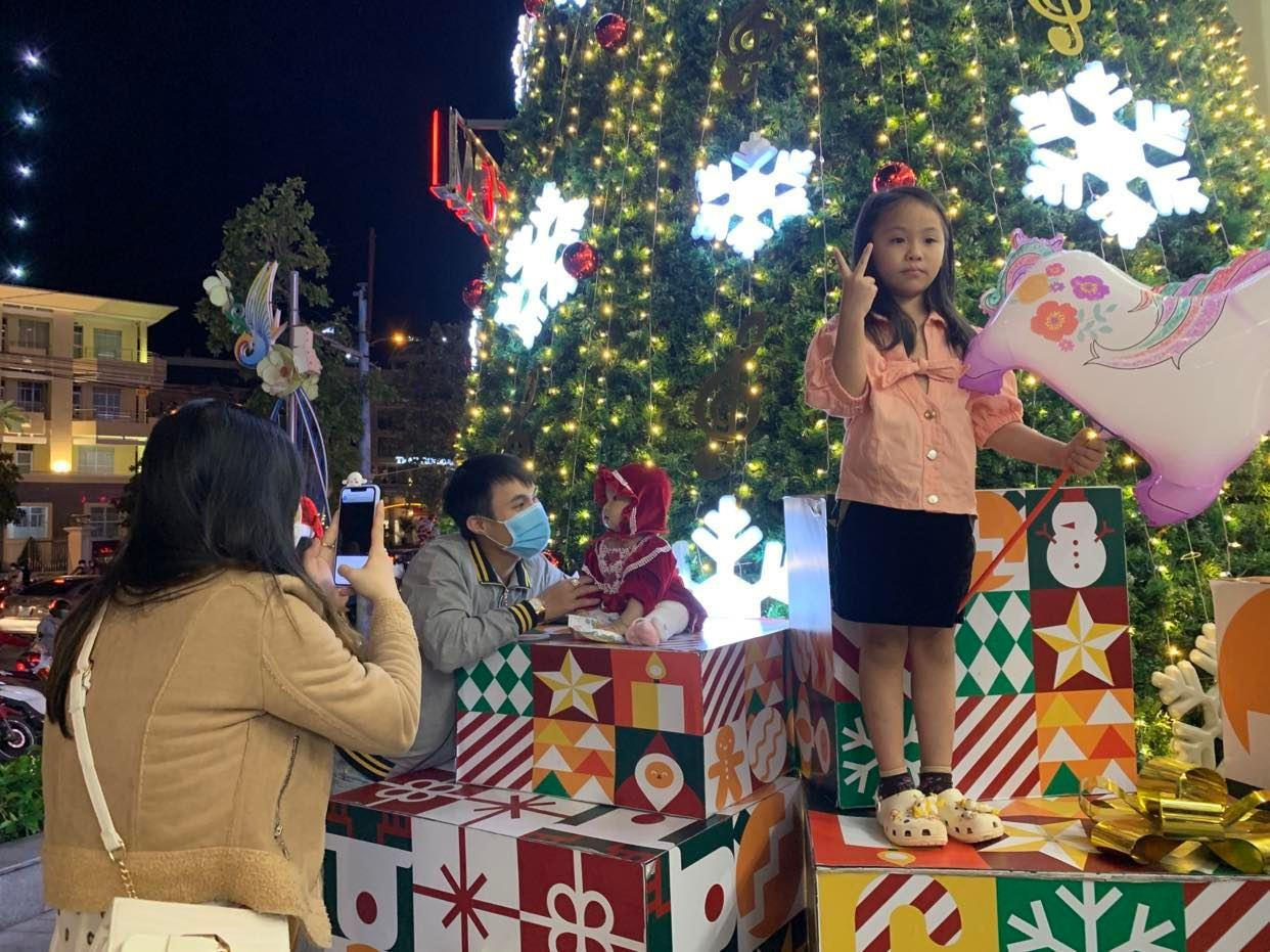 Mọi người chụp ảnh trong không khí Giáng sinh bên ngoài một trung tâm thương mại