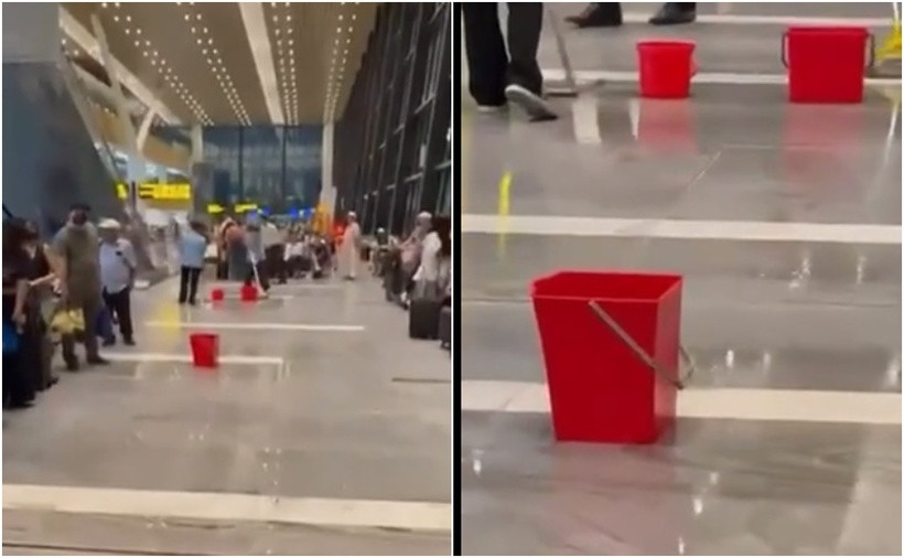 Nhân viên lau dọn vị trí bị dột nước mưa tại nhà ga T3 trong cơn mưa chiều 7/5. Ảnh: Chụp từ video.