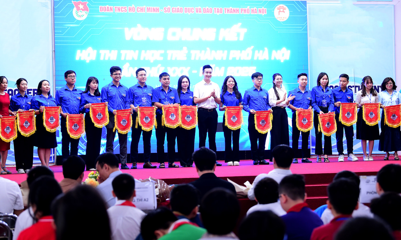 Anh Đào Đức Việt trao tặng cờ lưu niệm cho các đơn vị tham gia Hội thi Tin học trẻ thành phố Hà Nội năm 2025. Ảnh: Xuân Tùng