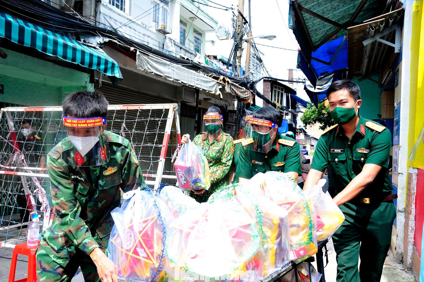 Đưa các phần quà trung thu vào các ngõ, hẻm ở quận 3 để trao tặng. Ảnh: BTL TPHCM