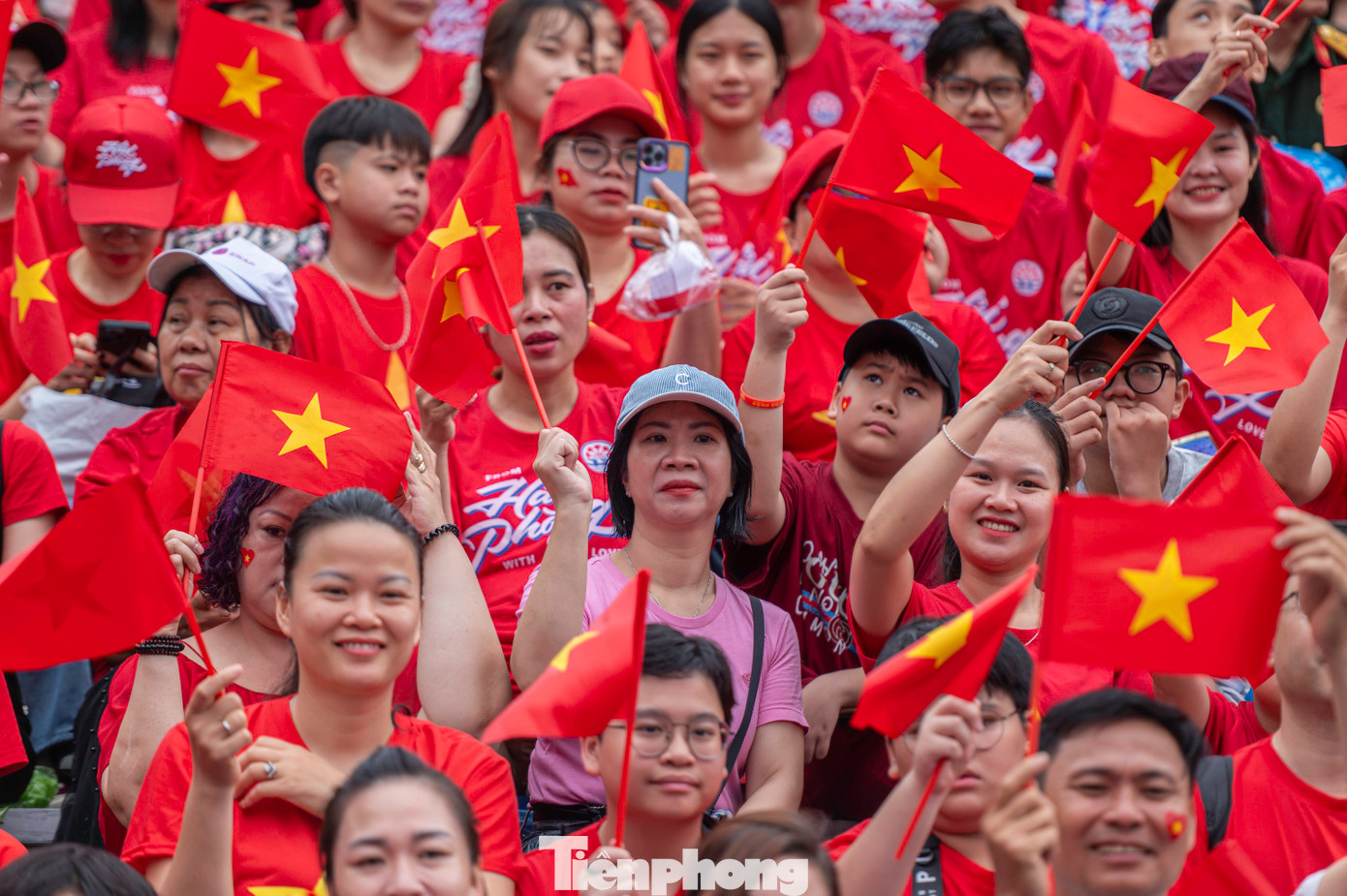 Hàng nghìn người dân mặc áo đỏ sao vàng, tay cầm cờ Tổ quốc.