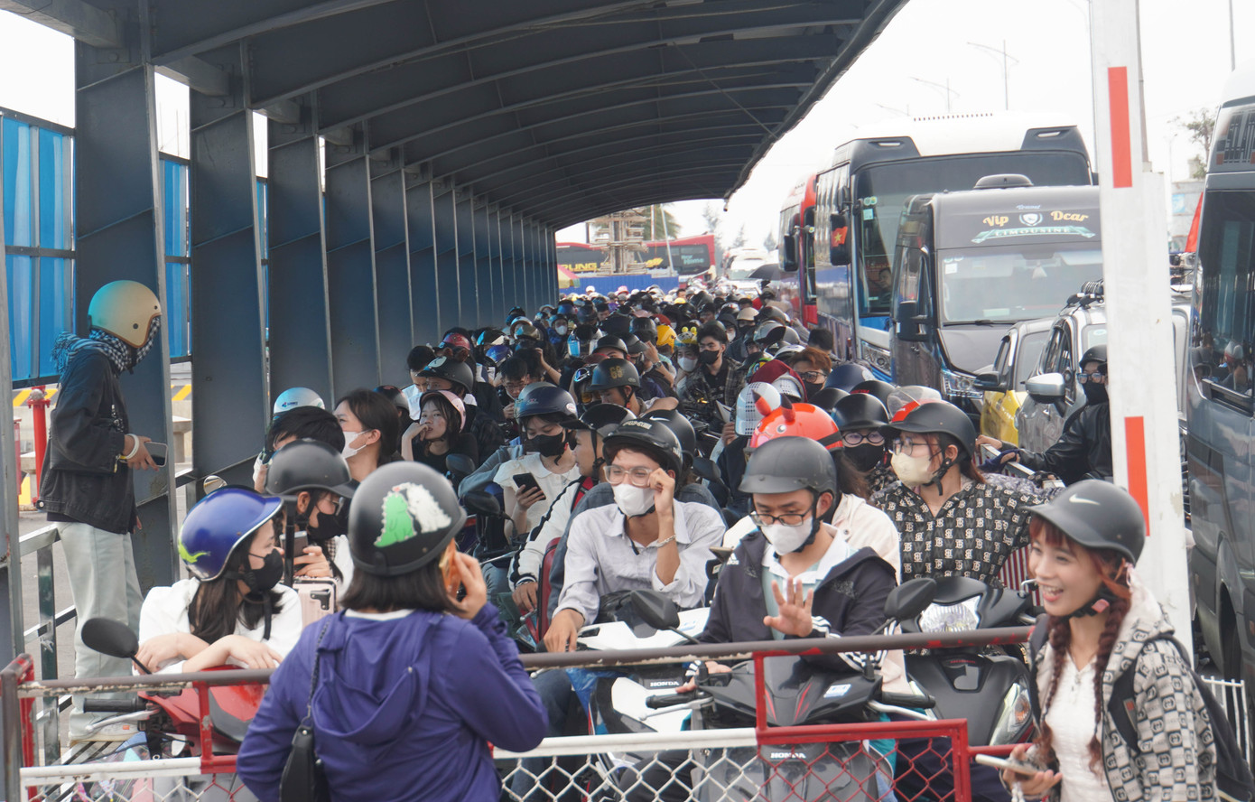 Trong khi đó, ở làn xe máy, hàng nghìn người xếp hàng chờ tới lượt lên phà ra đảo Cát Bà.