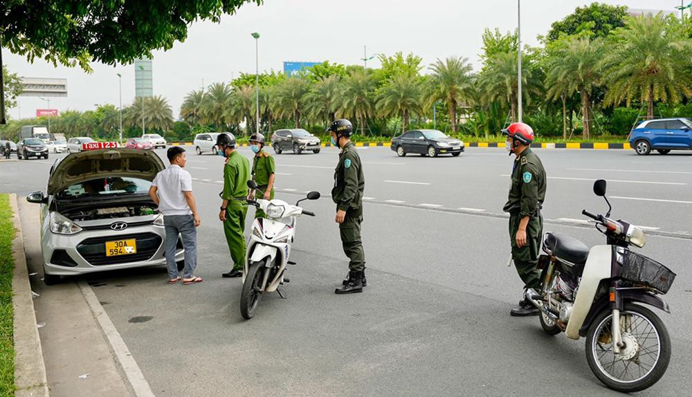 Lực lượng an ninh sân bay Nội Bài và Công an huyện Sóc Sơn (Hà Nội) kiểm tra, nhắc nhở xe taxi dừng đỗ, đón trả khách sai quy định tại khu vực trước sân bay Nội Bài.