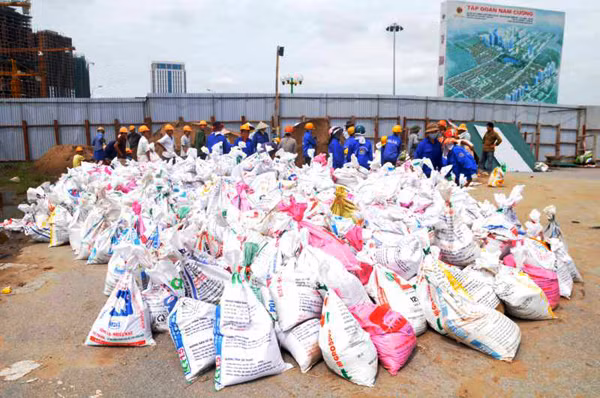 Hàng chục công nhân được huy động để xúc cát vào các bao tải, dựng tường bao bảo vệ, tránh các đợt mưa bão tiếp theo ảnh hưởng tới quá trình thi công