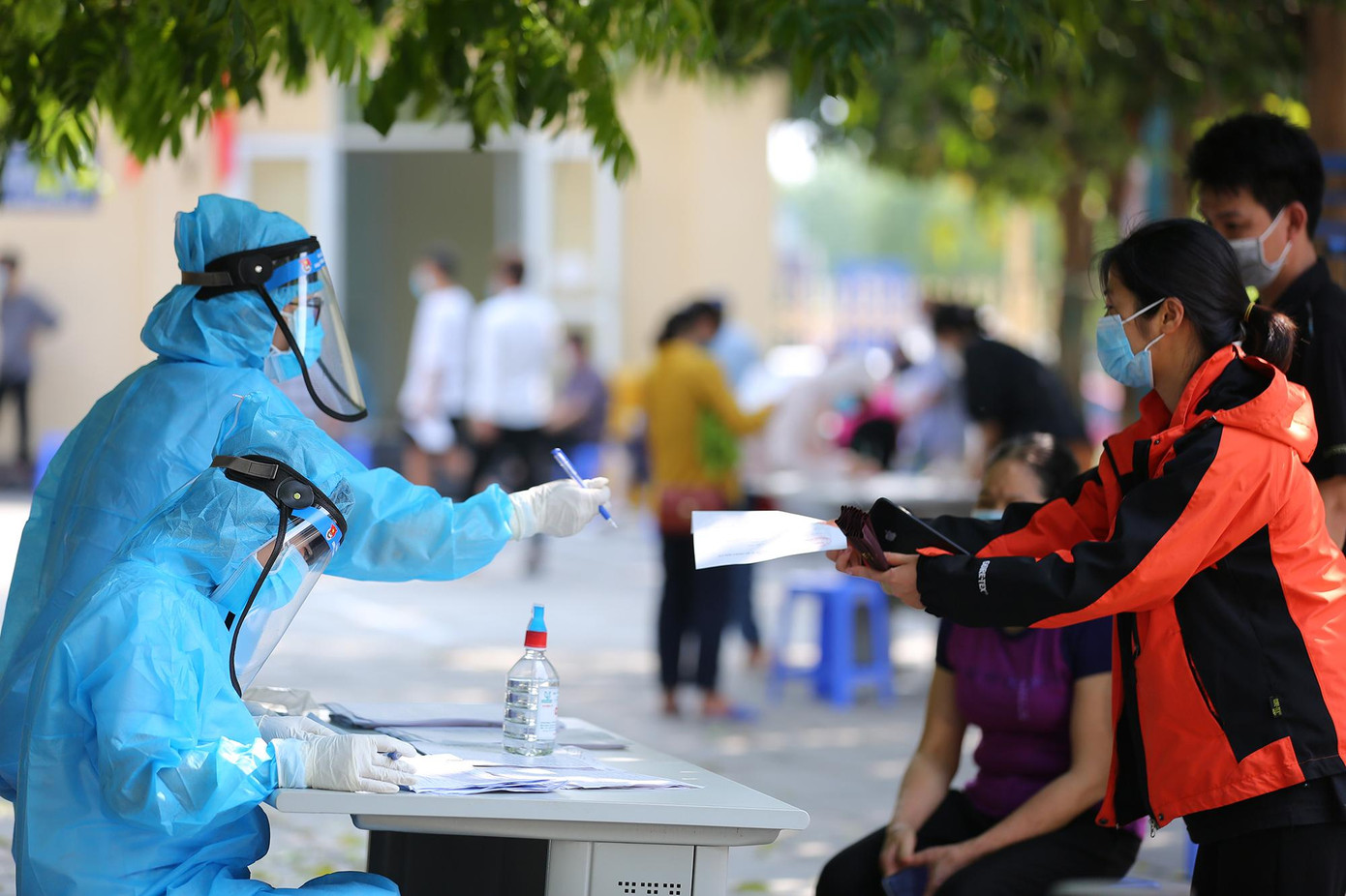 Những người dân đến lấy mẫu xét nghiệm đều được đo thân nhiệt và rửa tay sát khuẩn.