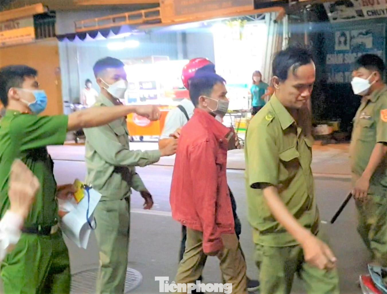 Công an đưa đối tượng Công (áo đỏ) về trụ sở để làm việc