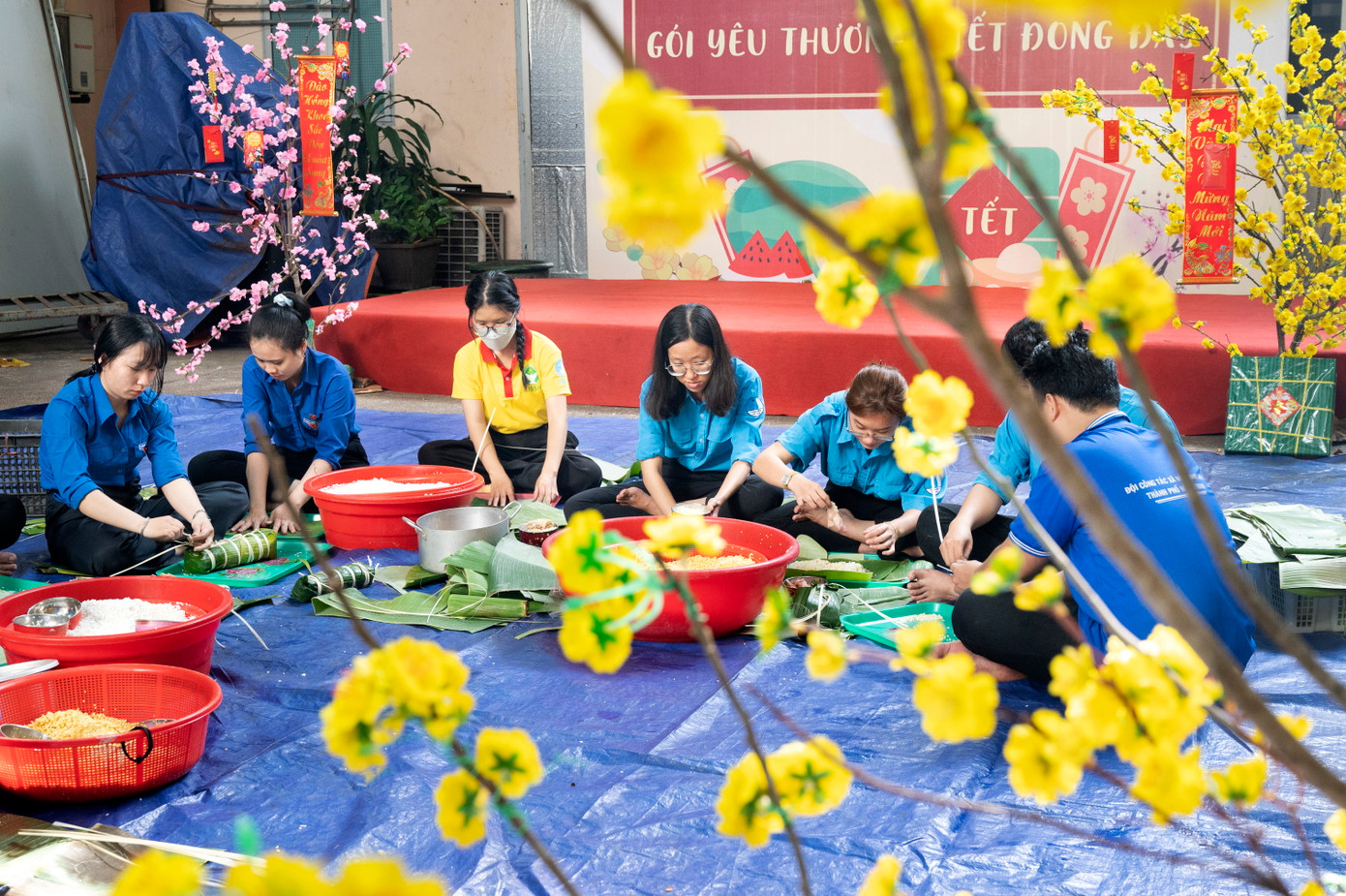 Các bạn đoàn viên thanh niên, tình nguyện viên gói bánh chưng, bánh tét gửi tặng bà con. Những phần quà ấm tình này sẽ được gửi tặng các hoàn cảnh khó khăn, người vô gia cư trong những ngày giáp Tết. Ảnh: Quốc Thanh