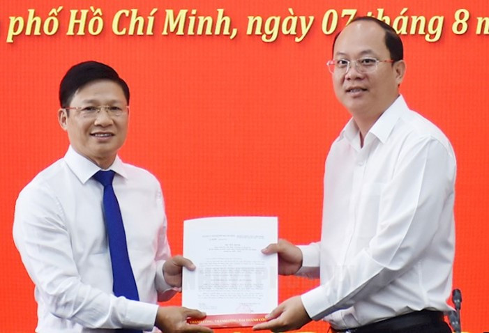 Phó Bí thư Thành ủy TPHCM Nguyễn Hồ Hải (bìa phải) trao quyết định cho ông Võ Minh Tuấn. Ảnh: Thành uỷ TPHCM