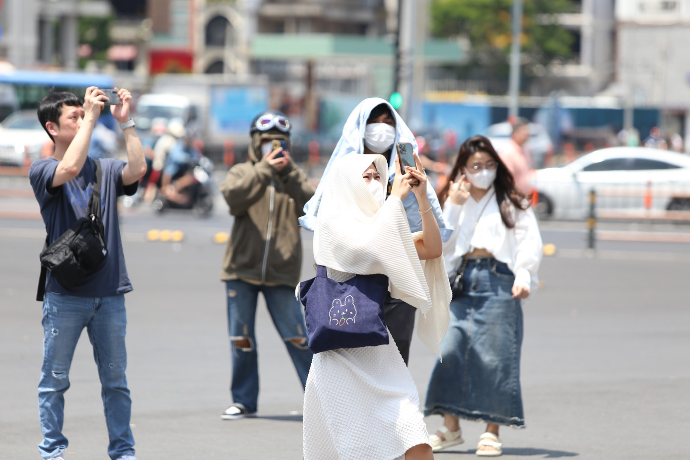 Bạn trẻ đội nắng chụp ảnh trước chợ Bến Thành.