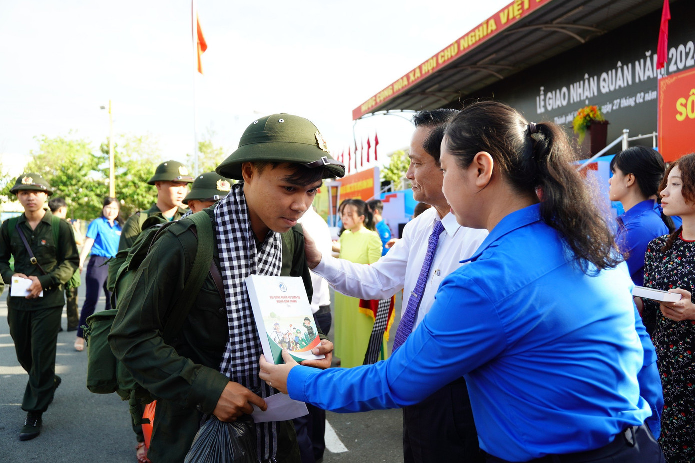 Chị Trịnh Thị Hiền Trân - Phó Bí thư Thành Đoàn TP. HCM, Chủ tịch Hội đồng Đội thành phố cùng lãnh đạo địa phương trao quà cho các tân binh trước khi lên xe về đơn vị thực hiện nghĩa vụ quân sự.