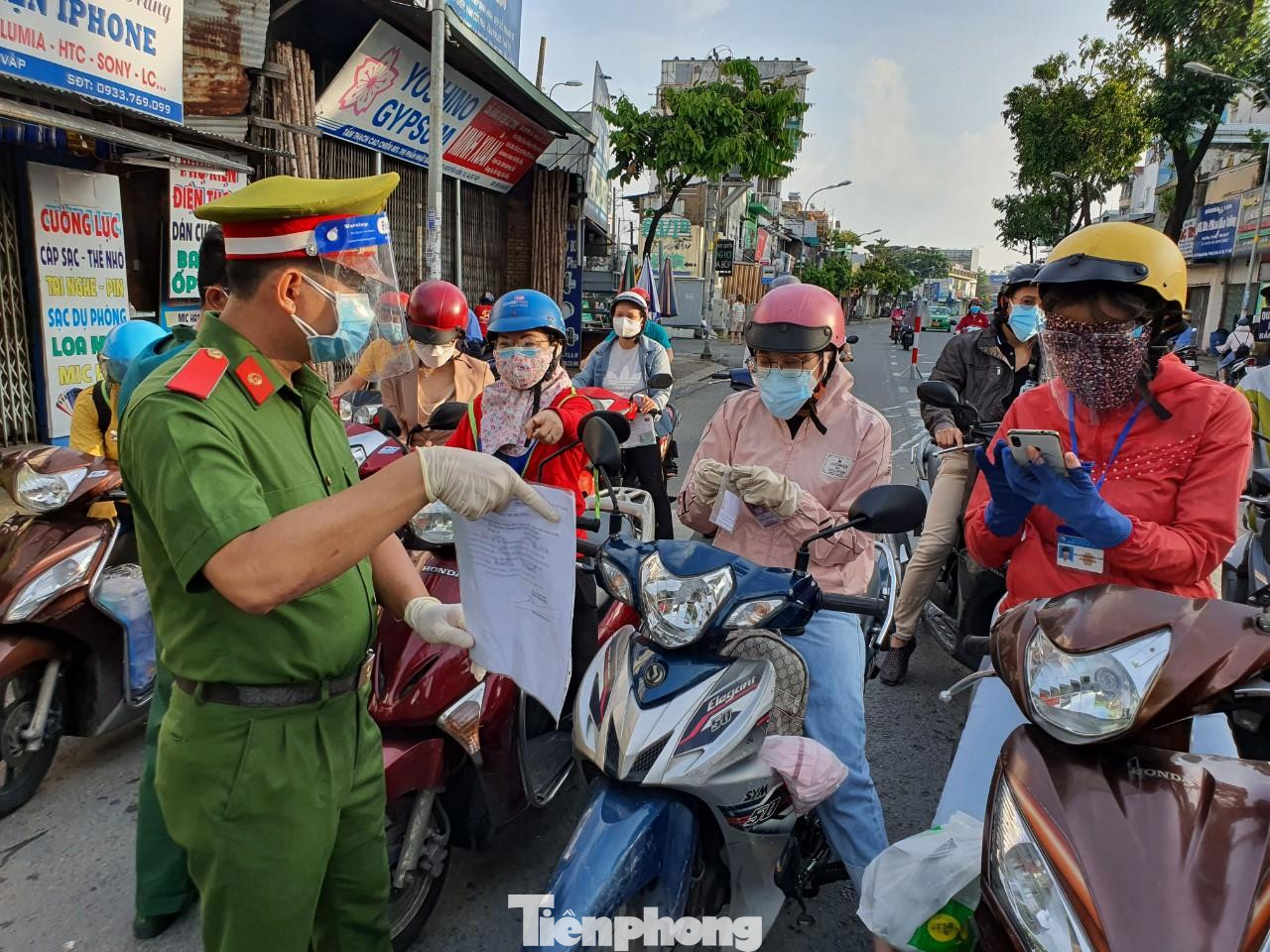 Lực lượng chức năng phổ biến giấy đi đường mới cho người dân