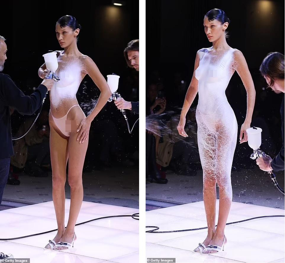 Siêu mẫu sinh năm 1996 được Coperni "chọn mặt gửi vàng" để thực hiện màn trình diễn thiết kế trang phục tại chỗ bằng cách phun sơn lên cơ thể người mẫu. Ảnh: Getty Images.