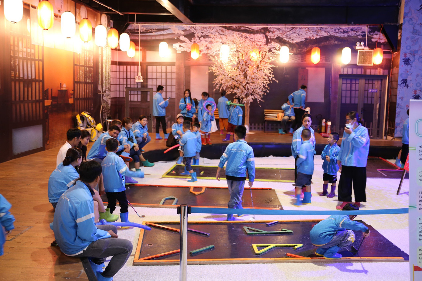 Các em bé chơi trò đánh golf mini tại sân băng