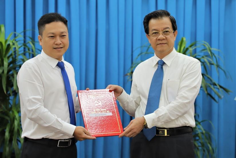 Ông Lê Hồng Quang - Bí thư Tỉnh uỷ An Giang (bên phải) trao Quyết định bổ nhiệm cho anh Lâm Thành Sĩ giữ chức Phó Trưởng Ban Tuyên giáo Tỉnh ủy An Giang.